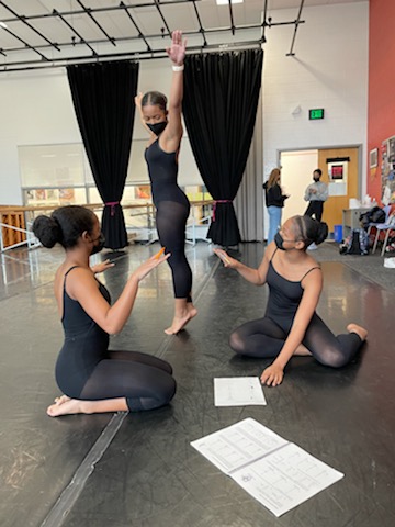 3 teen dancers discussing notation