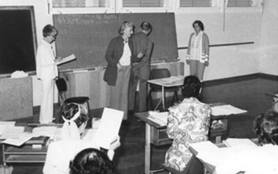 picture of Ann Hutchinson Guest teaching while participants are seated looking at notation.