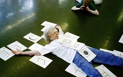 photo of Ann Hutchinson Guest laying down covered in the Parts of the Body symbols