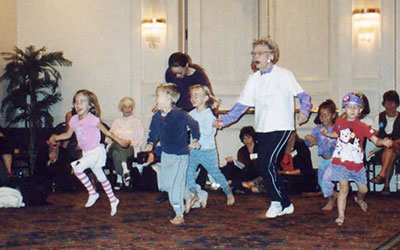 photo of Ann Hutchinson Guest dancing wtih children